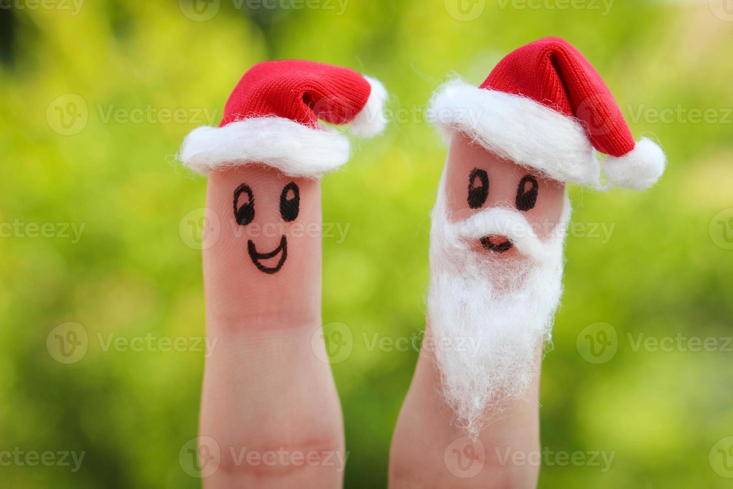 Face painted on the fingers. Santa Claus gives gifts photo