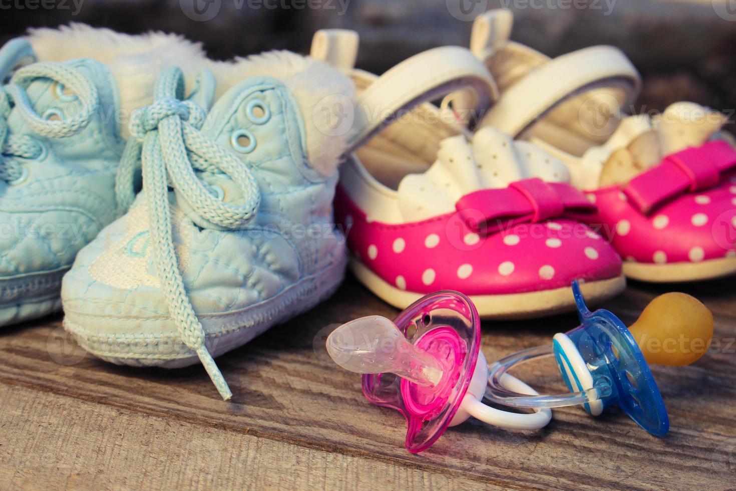 Baby shoes and pacifiers pink and blue photo