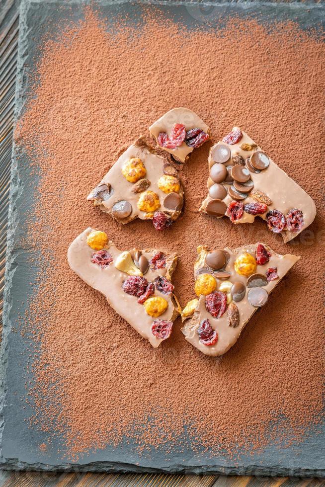 Chocolate bar with nuts and fruits photo