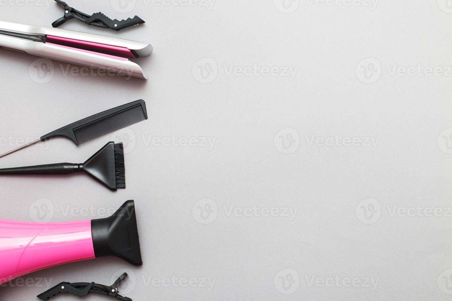 various hairdressing tools like hair dryer, comb on a gray background. beauty salon concept photo