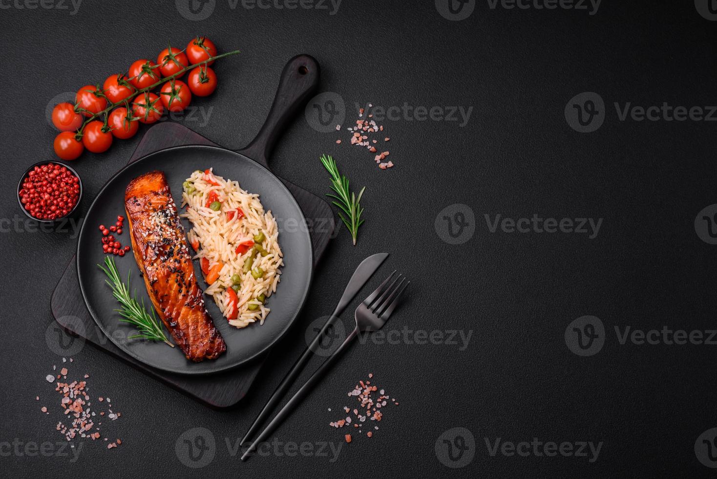 Delicious red salmon fish grilled with sauce and sesame seeds with rice and vegetables photo