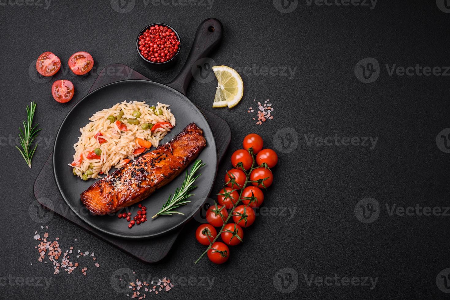 Delicious red salmon fish grilled with sauce and sesame seeds with rice and vegetables photo