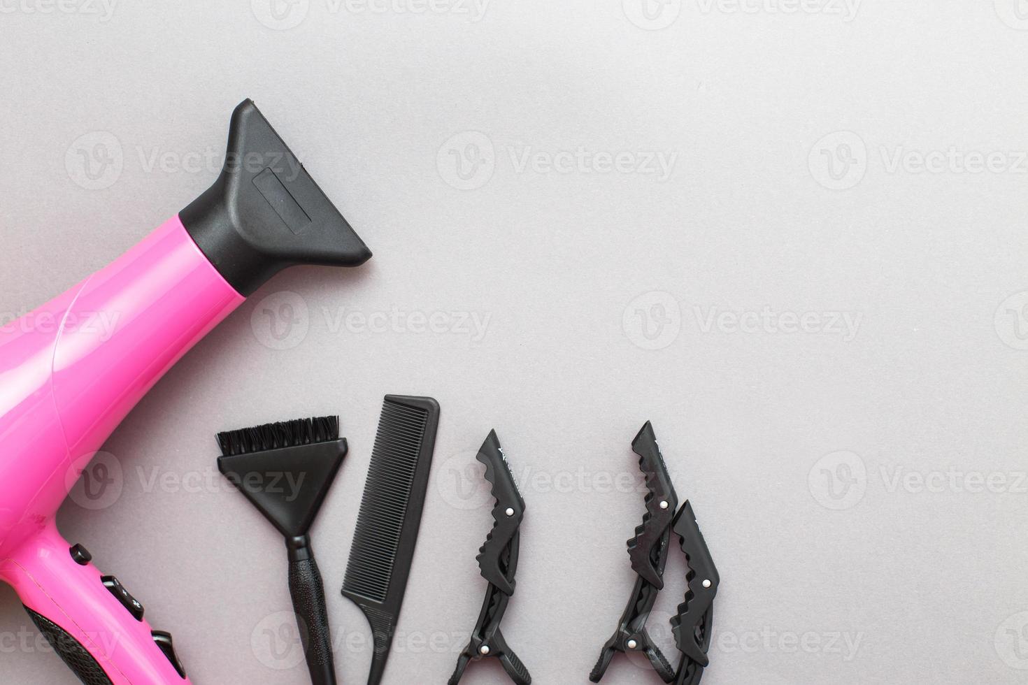 various hairdressing tools like hair dryer, comb on a gray background. beauty salon concept photo