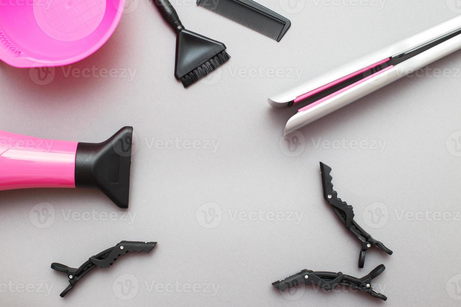 various hairdressing tools like hair dryer, comb on a gray background. beauty salon concept photo