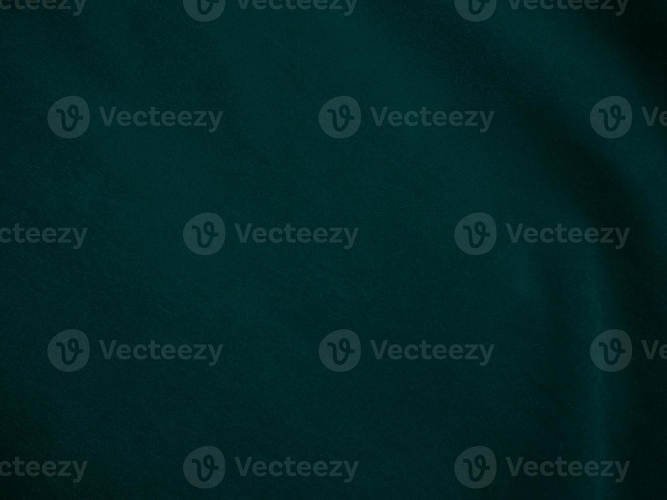 Dark green old velvet fabric texture used as background. Empty green fabric background of soft and smooth textile material. There is space for text.. photo