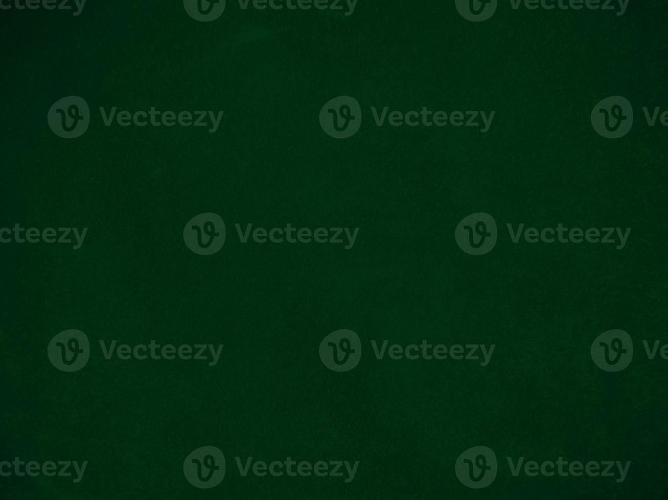Dark green old velvet fabric texture used as background. Empty green fabric background of soft and smooth textile material. There is space for text.. photo