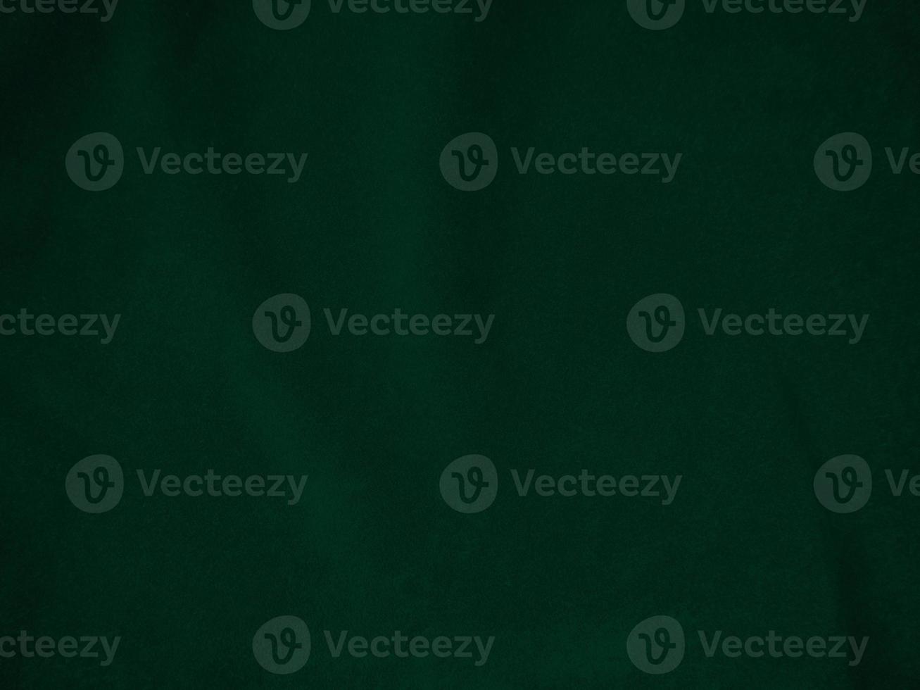 Dark green old velvet fabric texture used as background. Empty green fabric background of soft and smooth textile material. There is space for text.. photo