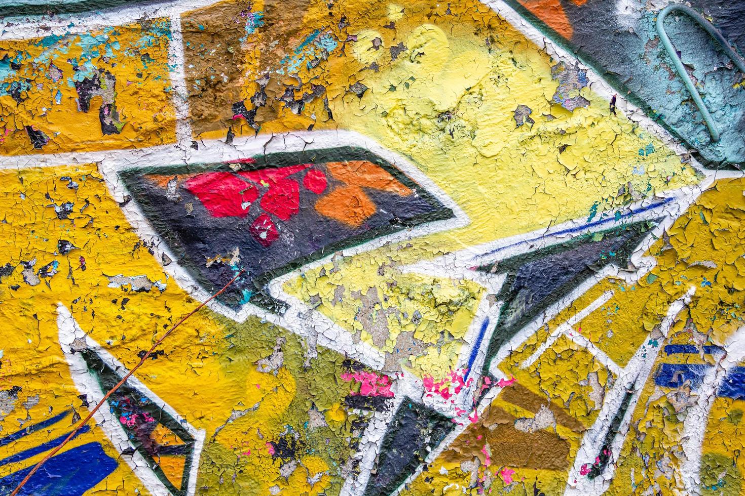 Abstract multicolored graffiti drawings. Wall painting yellow and grey. Cement background with texture. photo
