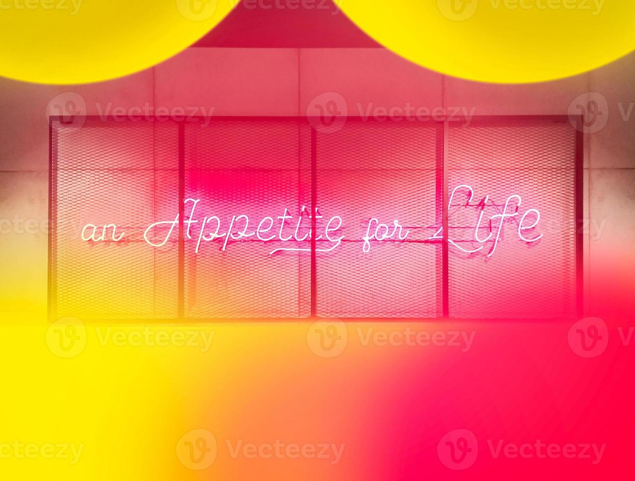 Sign in English with neon illumination and the inscription an Appetite for Life. photo