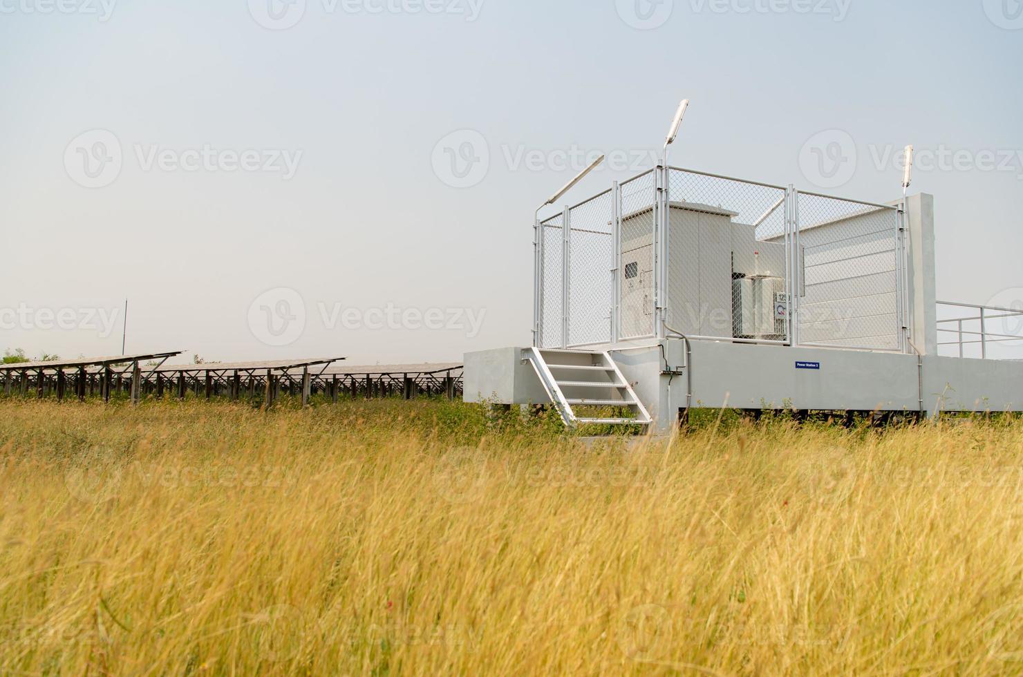 The field of solar panels with an energy storage station located in the middle of a solar cell panel on an area of hundreds of acres photo