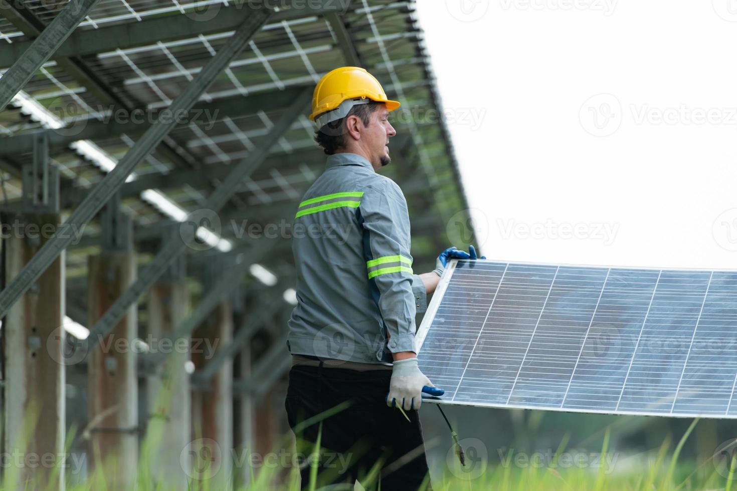 Engineering and technician unloading repaired solar panels to be installed on the rows of solar cells lined up on hundreds of acres of grass photo
