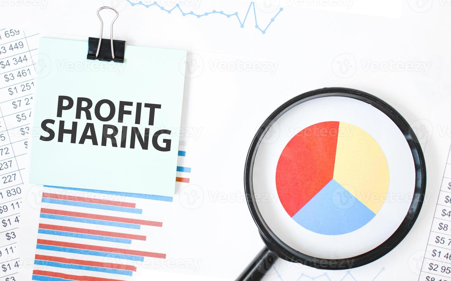 Green card on the white notepad and magnifier on the financial documentation. Text Rebrand. Business concept photo