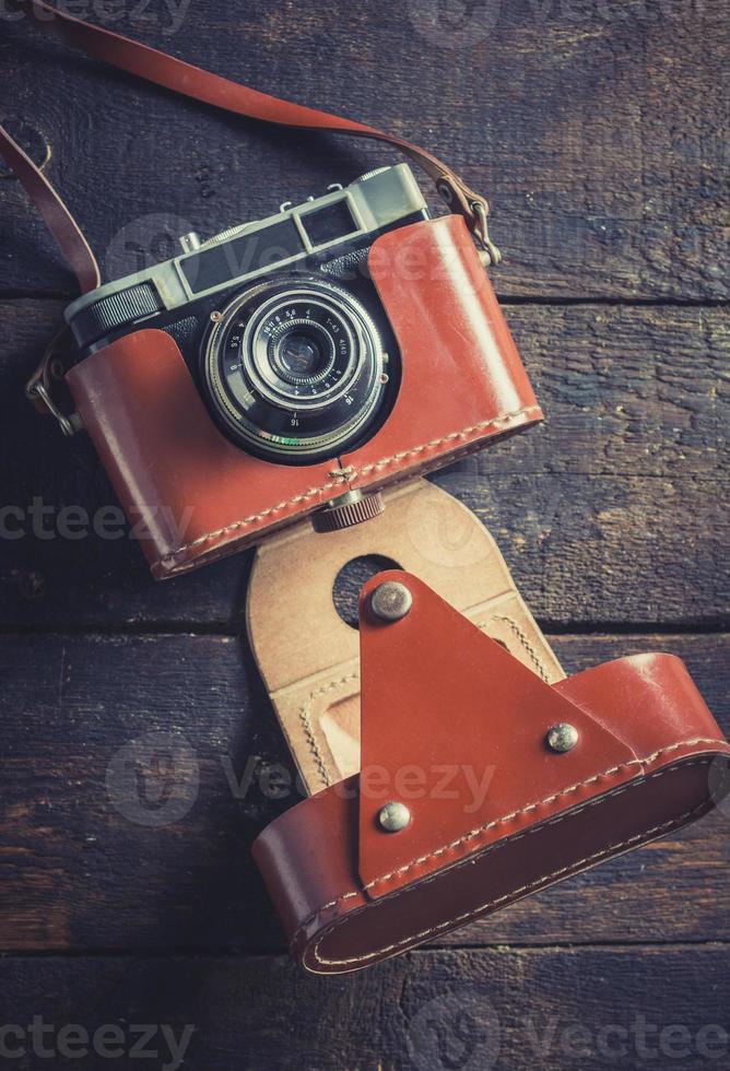 Old camera on wooden background photo