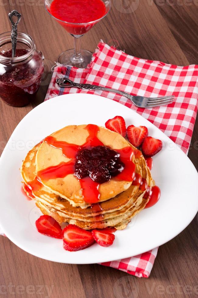 Strawberries jam and homemade pancakes photo