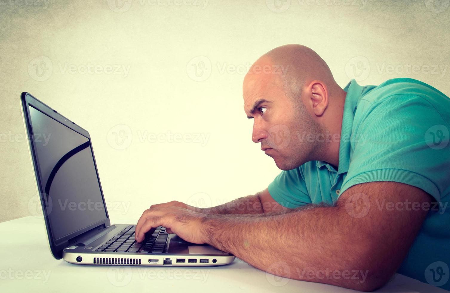 Man looking at laptop computer photo