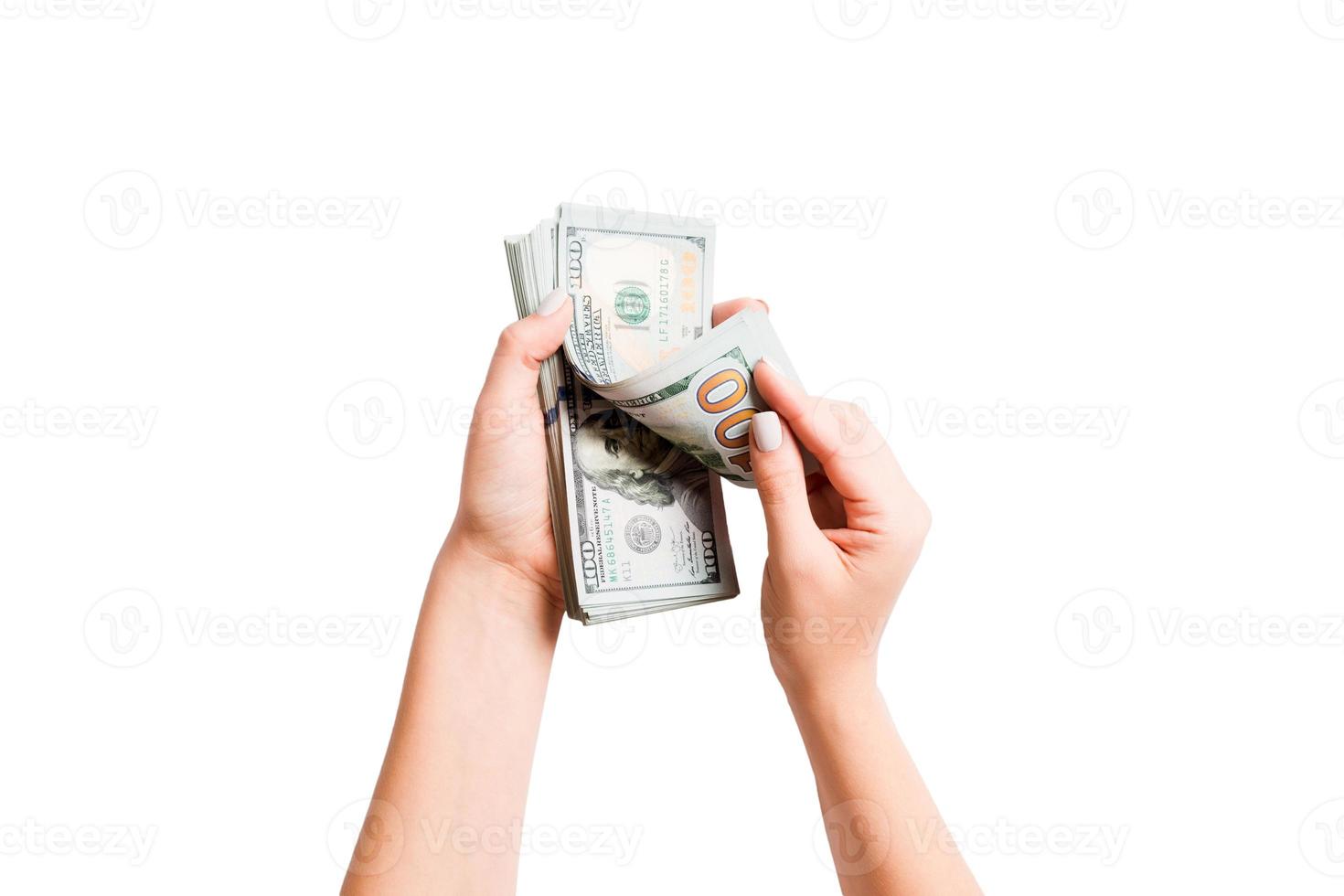 Top view of female hands counting dollar banknotes on white isolated background. Investment and prosperity concept photo