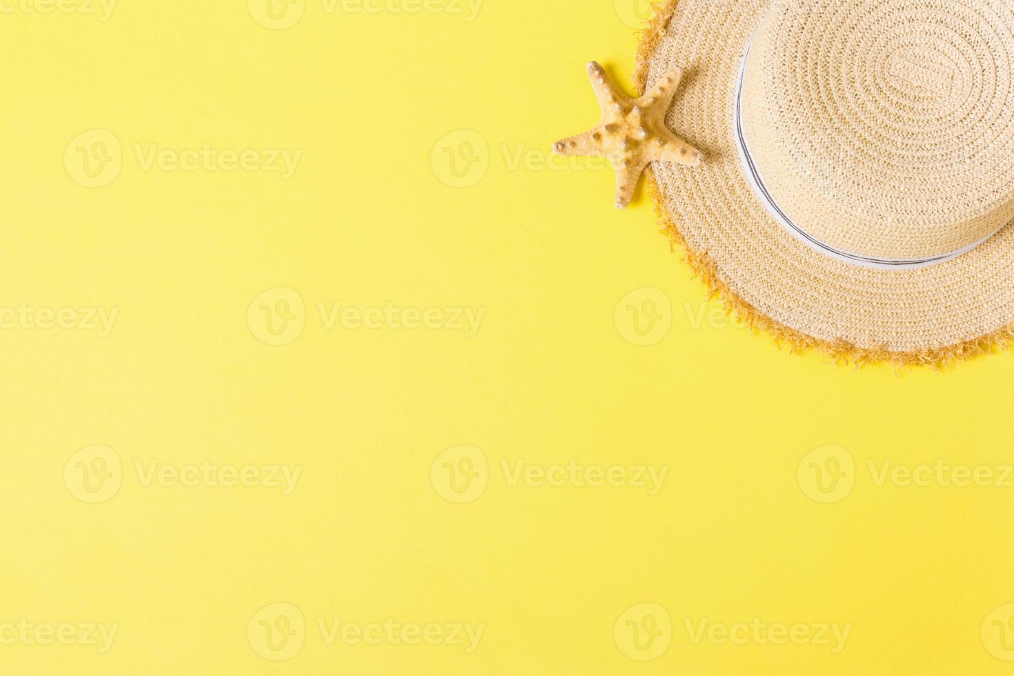 yellow retro straw hat with seastar top view with copy space. summer concept on yellow background photo