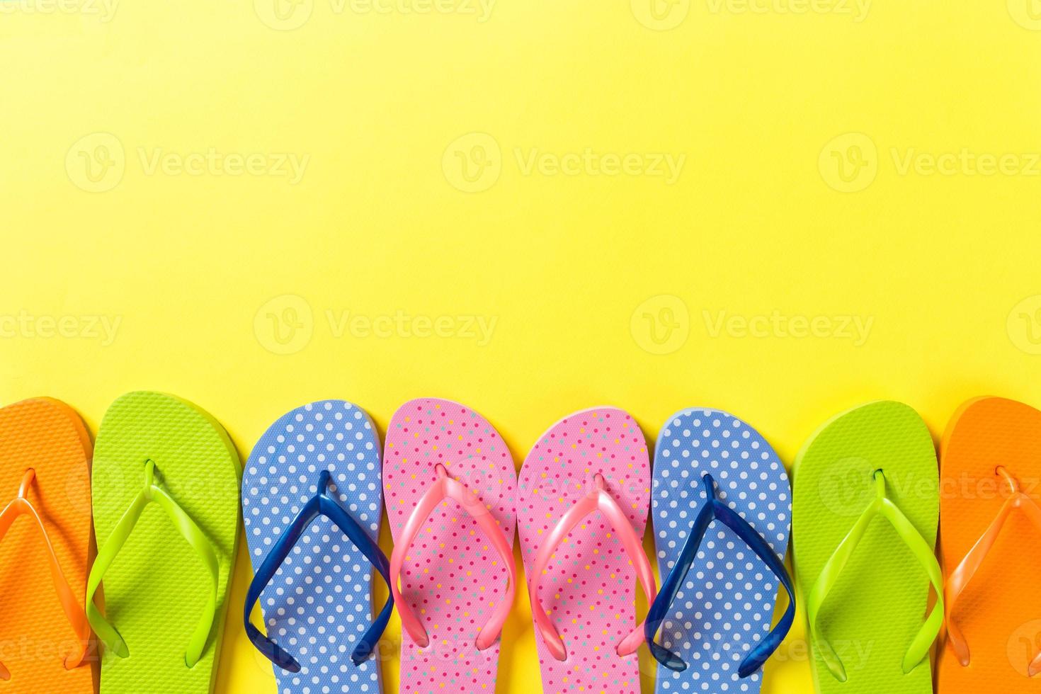 a lot of flip flop colored sandals, summer vacation on colored background, copy space top view photo