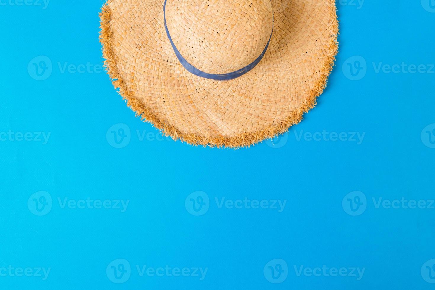 yellow retro straw hat top view with copy space. summer concept on blue background photo