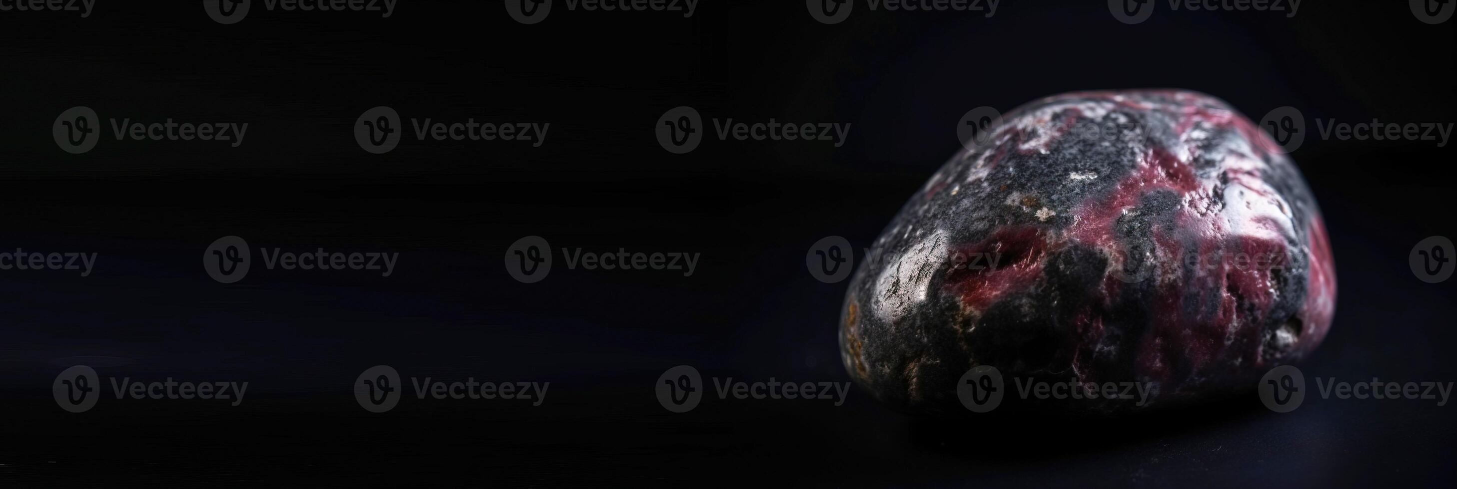 Taaffeite is a rare precious natural stone on a black background. . Header banner mockup with space. photo