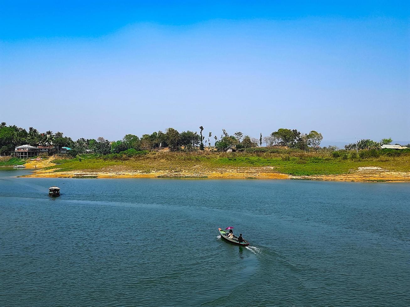 A boat on the water with a view of the island in the background photo