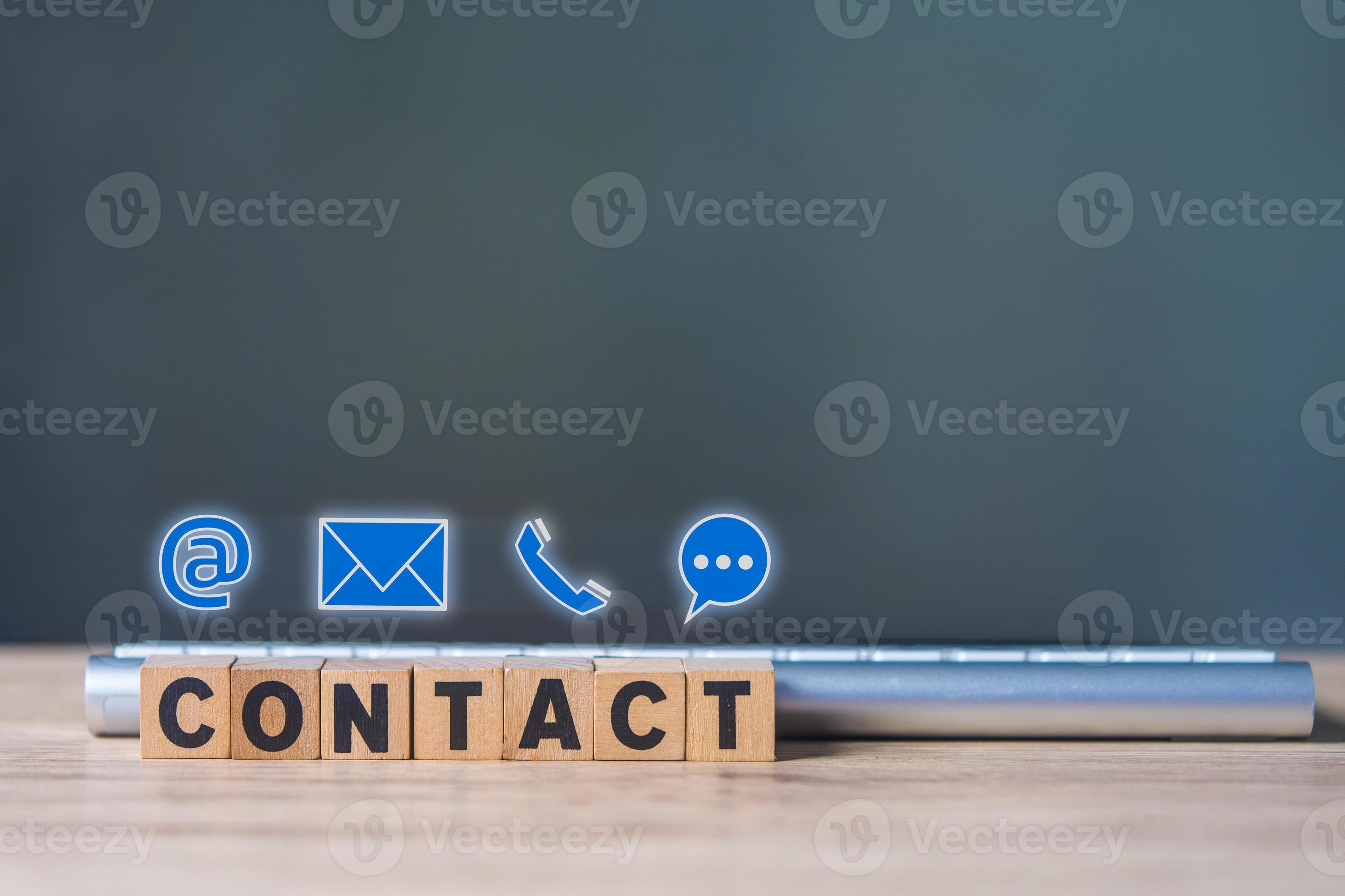 The words Contact written in wooden blocks placed in front of keyboard