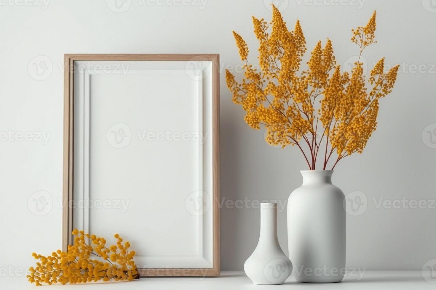 Wooden thin vertical frame mock up beside concrete vase with dry flowers over white wall. Mockup concept. photo