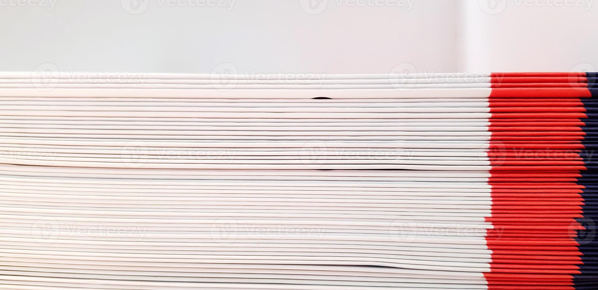 Close up pattern and line of white, red and blue spine or saddle book are sorting and stacking for background with above space. Art group of object, Education and Library concept photo