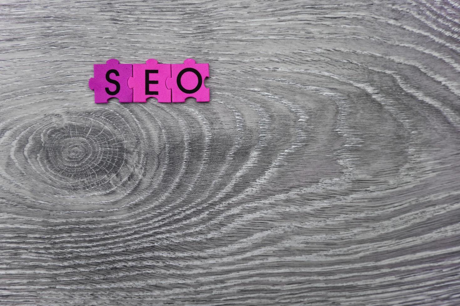 closeup shot of seo word on gray wooden background photo