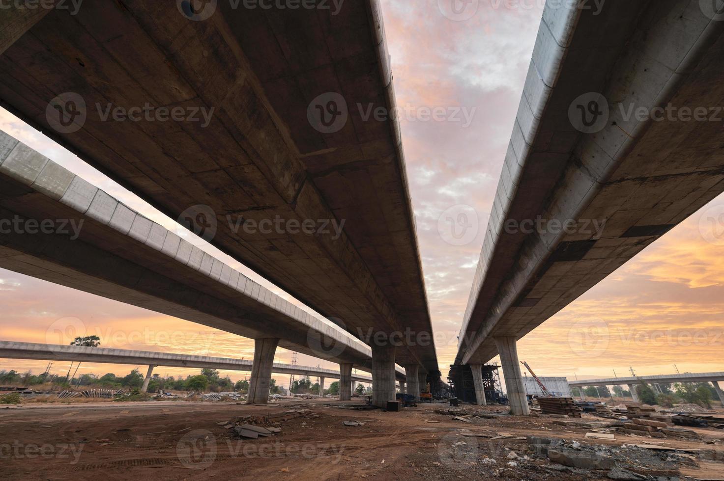 Construction of asphalt highways and overpasses in Asia, view of road junction against the sky photo