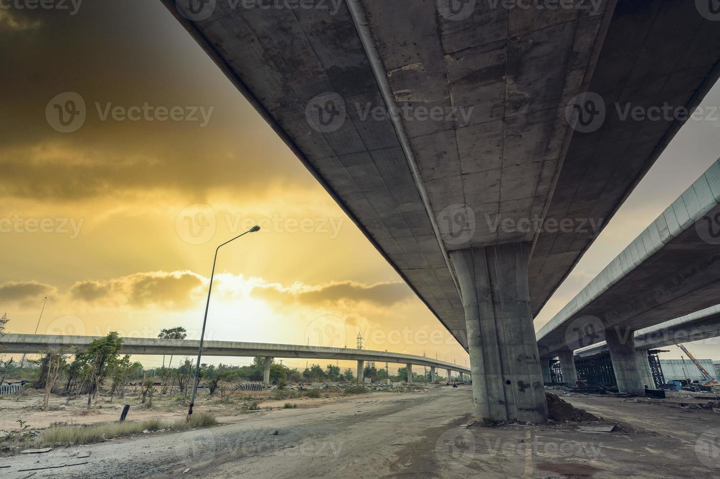 Construction of asphalt highways and overpasses in Asia, view of road junction against the sky photo