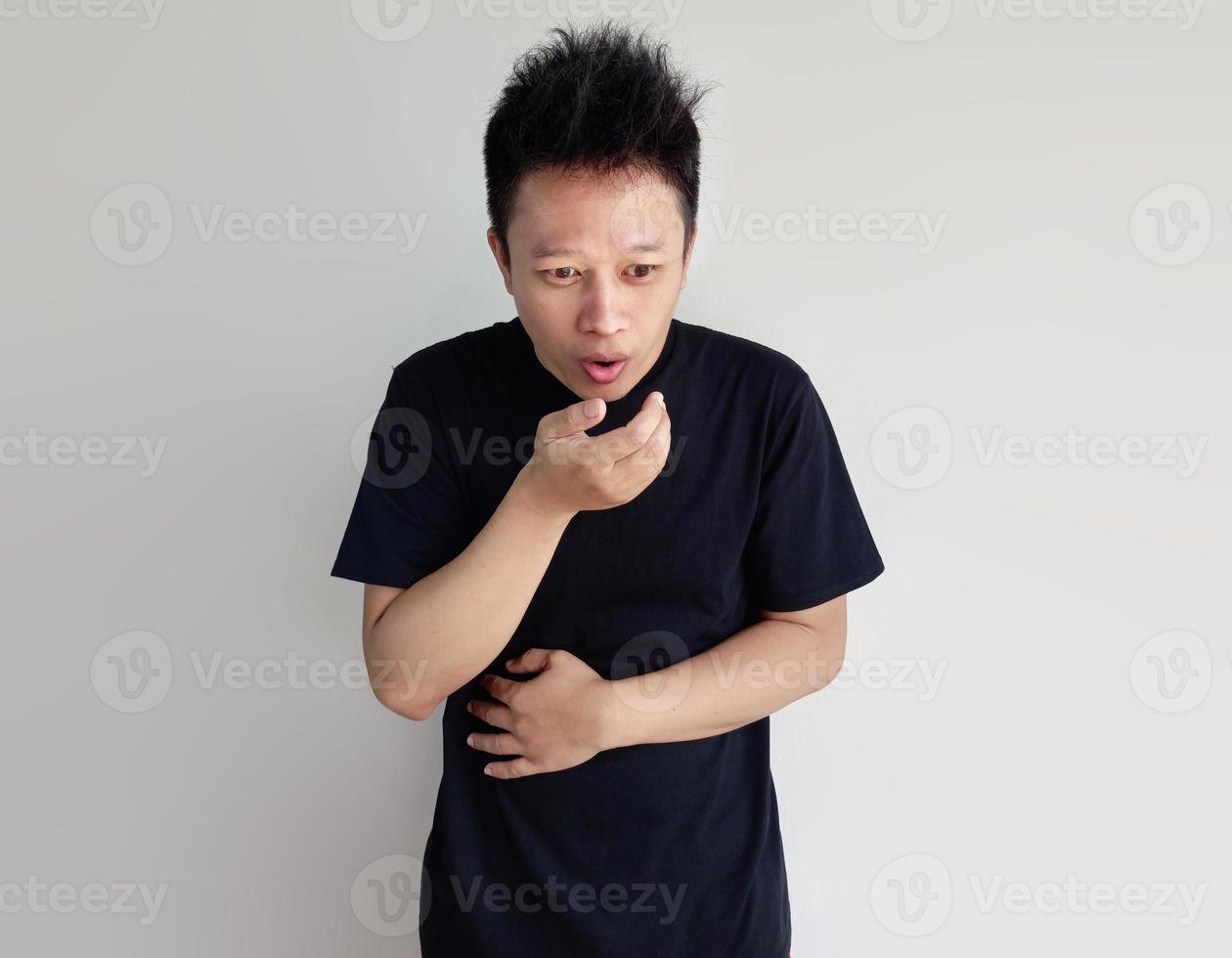 Young man having stomach ache and nausea isolated on plain background photo