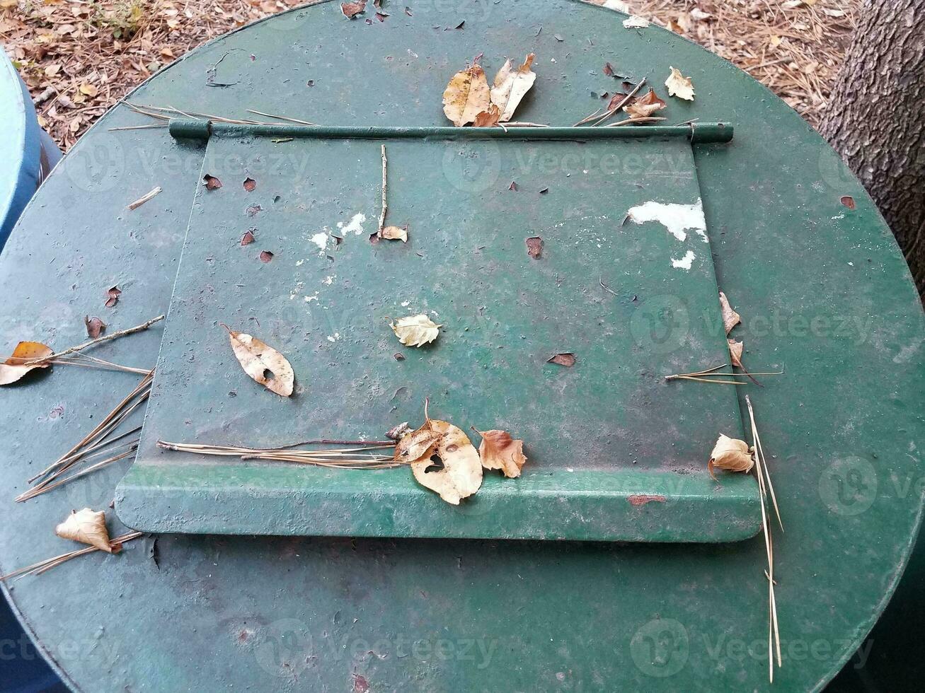 green metal garbage or trash can with closed door photo