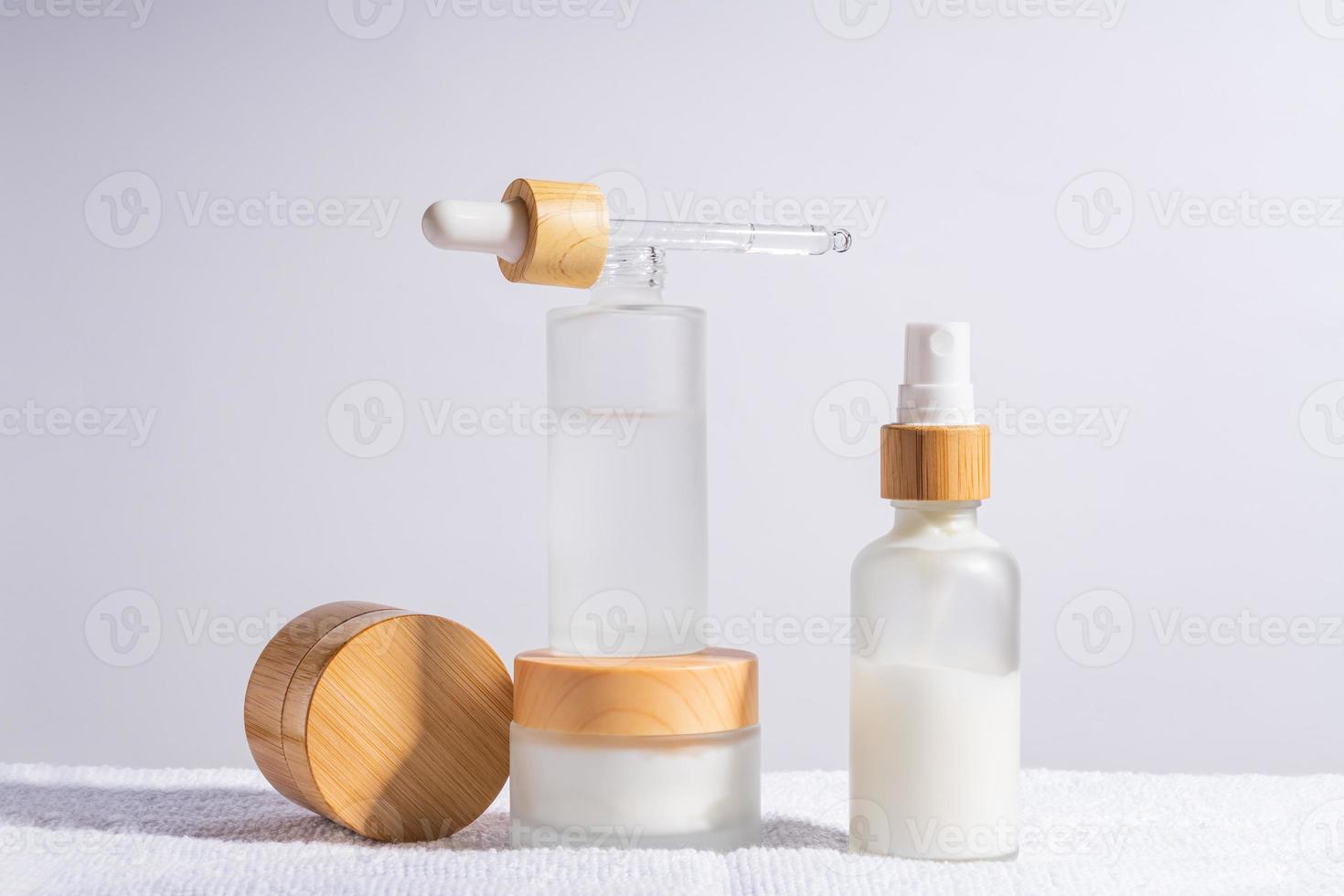 anti-aging collagen facial serum in matte glass bottle and face cream on white background with copy space. Natural Organic Cosmetic Beauty Concept. Mockup for branding photo