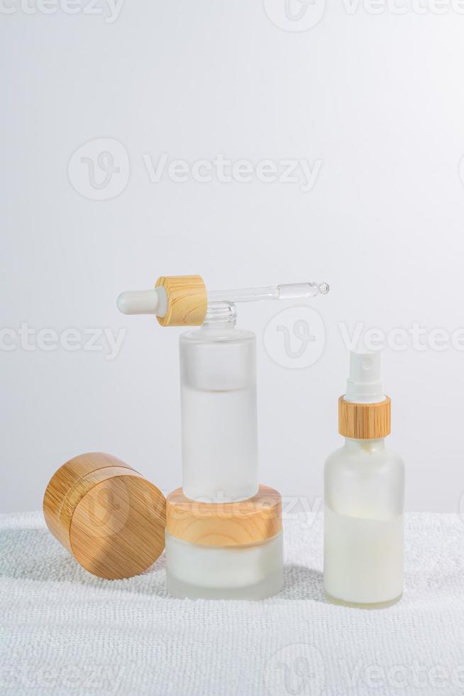 Cosmetics packaging. Set of different cosmetic bottles of cream or serum on a white podium. Blank packaging. Natural beauty spa product concept. Beauty. Mock-up. photo