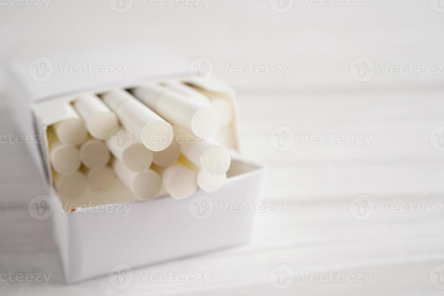 Cigarette in pack, roll tobacco in paper with filter tube, No smoking concept. photo