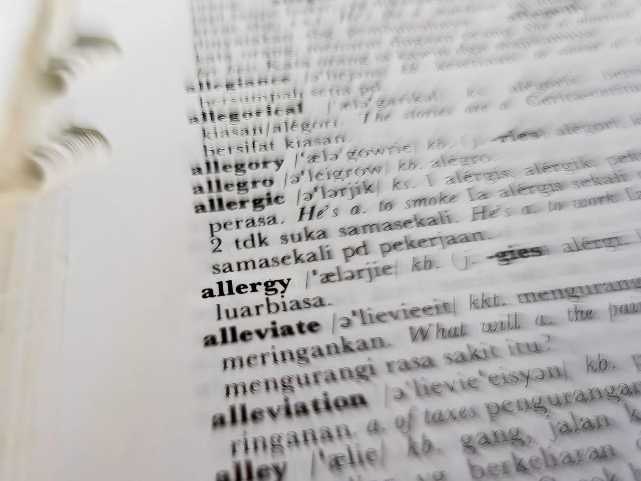 a close up of the word allergy in the English to Indonesian dictionary. For word background or wallpaper photo