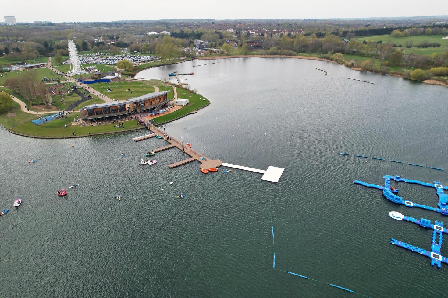 beautiful View of Willen Lake Park with Local and Tourist Public Enjoying the Beauty of Lake and Park by Walking Around with Their Families. Footage Was Captured on 09-April-2023 at Milton Keynes UK photo