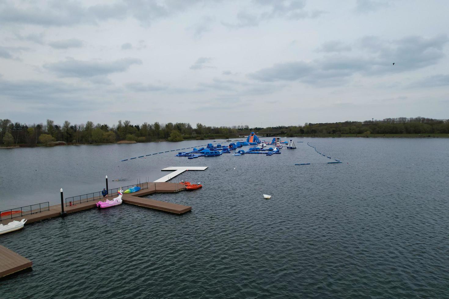beautiful View of Willen Lake Park with Local and Tourist Public Enjoying the Beauty of Lake and Park by Walking Around with Their Families. Footage Was Captured on 09-April-2023 at Milton Keynes UK photo