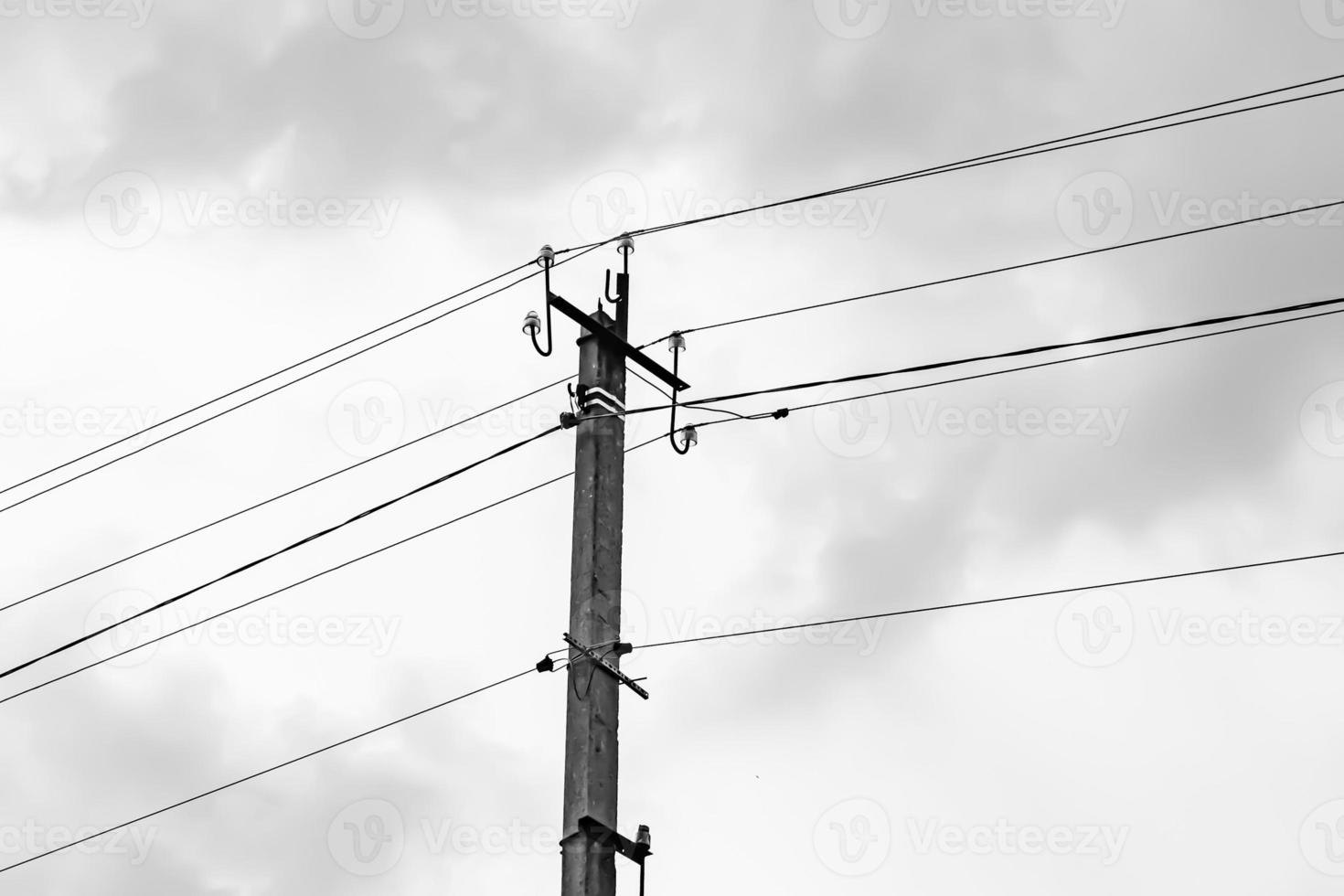 Power electric pole with line wire on light background close up photo
