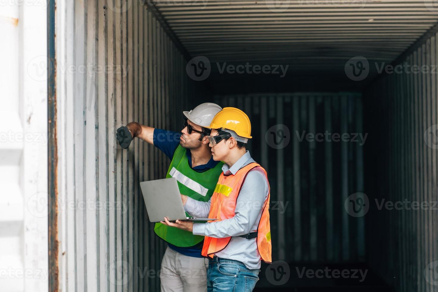 Team Engineer and worker wear safety uniform check control loading freight cargo container use computer laptop at commercial dock warehouse,transportation import,export logistic industrial service photo