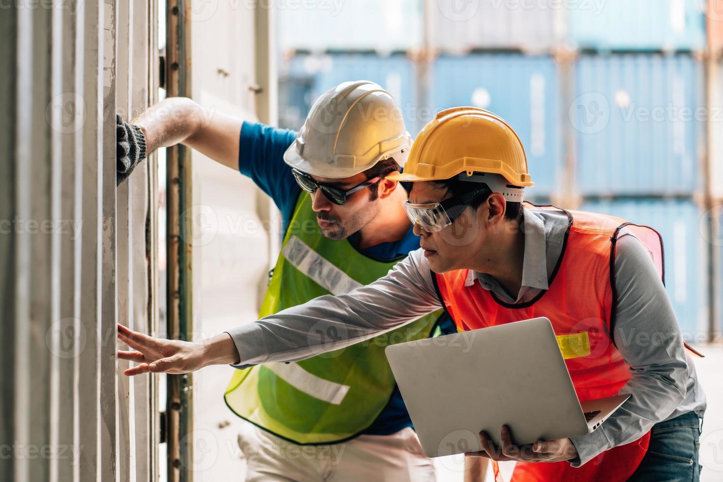 Team Engineer and worker wear safety uniform check control loading freight cargo container use computer laptop at commercial dock warehouse,transportation import,export logistic industrial service photo