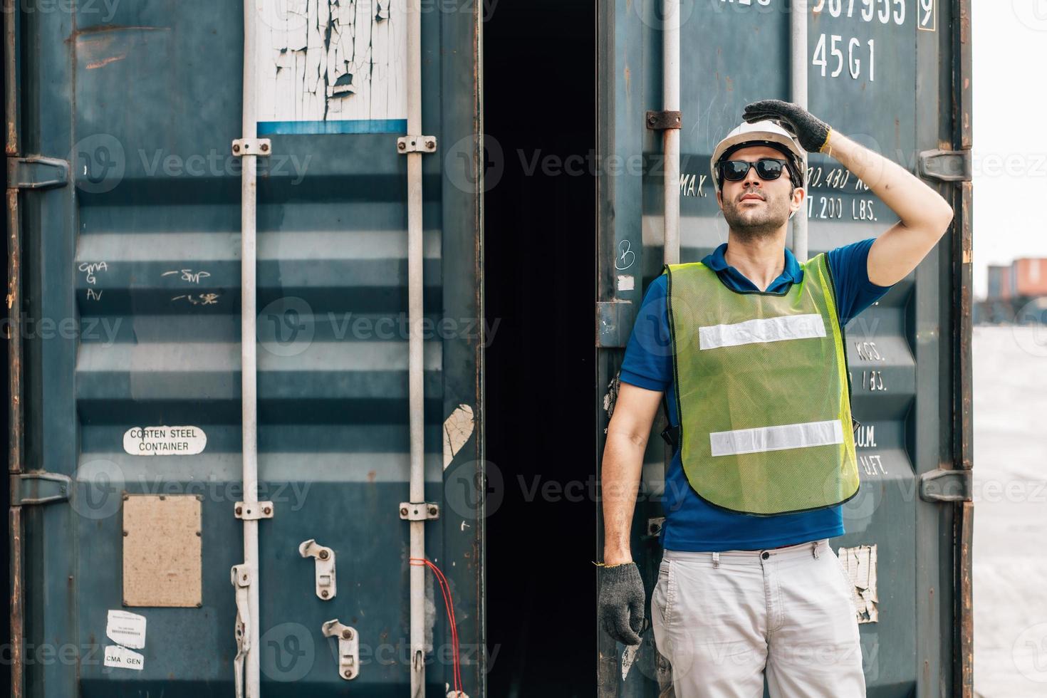 Engineer wear safety uniform check control loading freight cargo container use computer laptop at commercial dock warehouse,transportation import,export logistic industrial service photo
