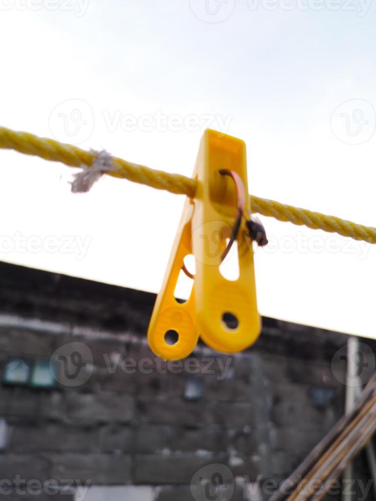moscas colgando en un pinza de ropa en un cadena. borroso y bokeh antecedentes foto