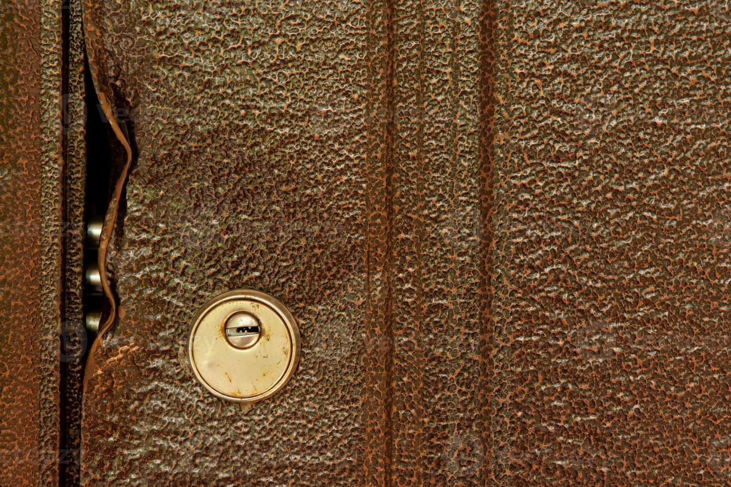 large durable lock is broken in a metal door close-up photo