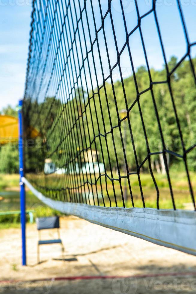 beach volleyball net against the blue sky on the beach, blurred focus photo