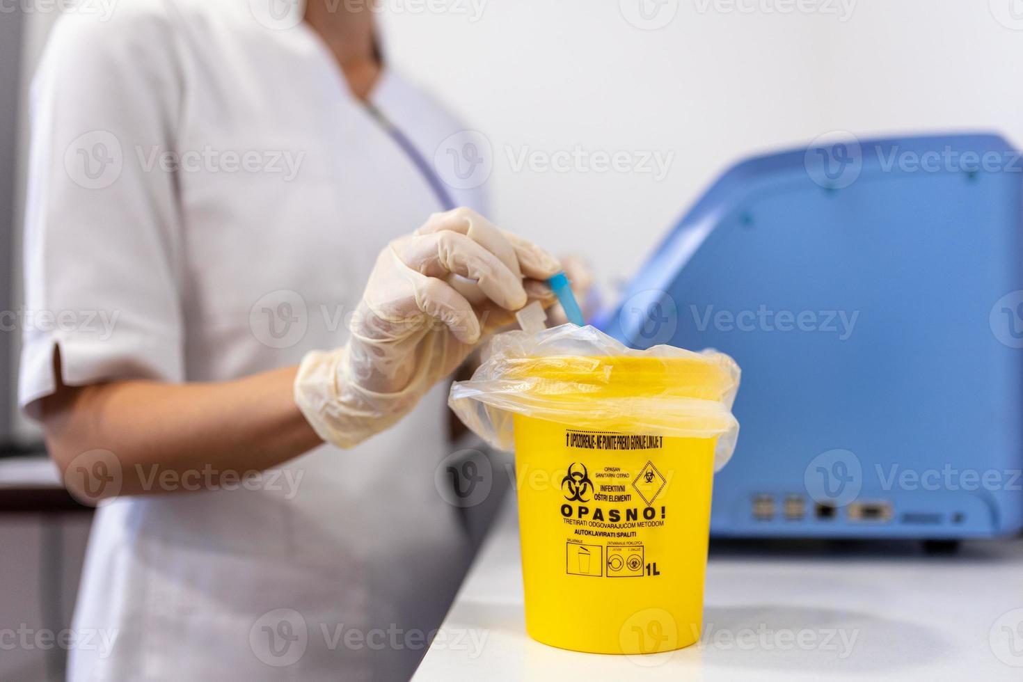 Throw away the medicine in the trash. Disposal container for Infectious waste, reducing medical waste disposal. Small Medical Waste sharps container with sharps for bio-hazard. photo