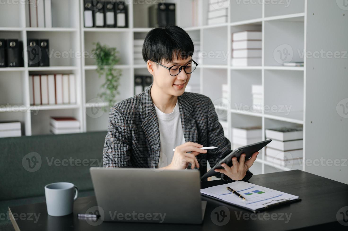 Young business man executive manager looking at laptop watching online webinar training or having virtual meeting video conference doing market research working in office. photo