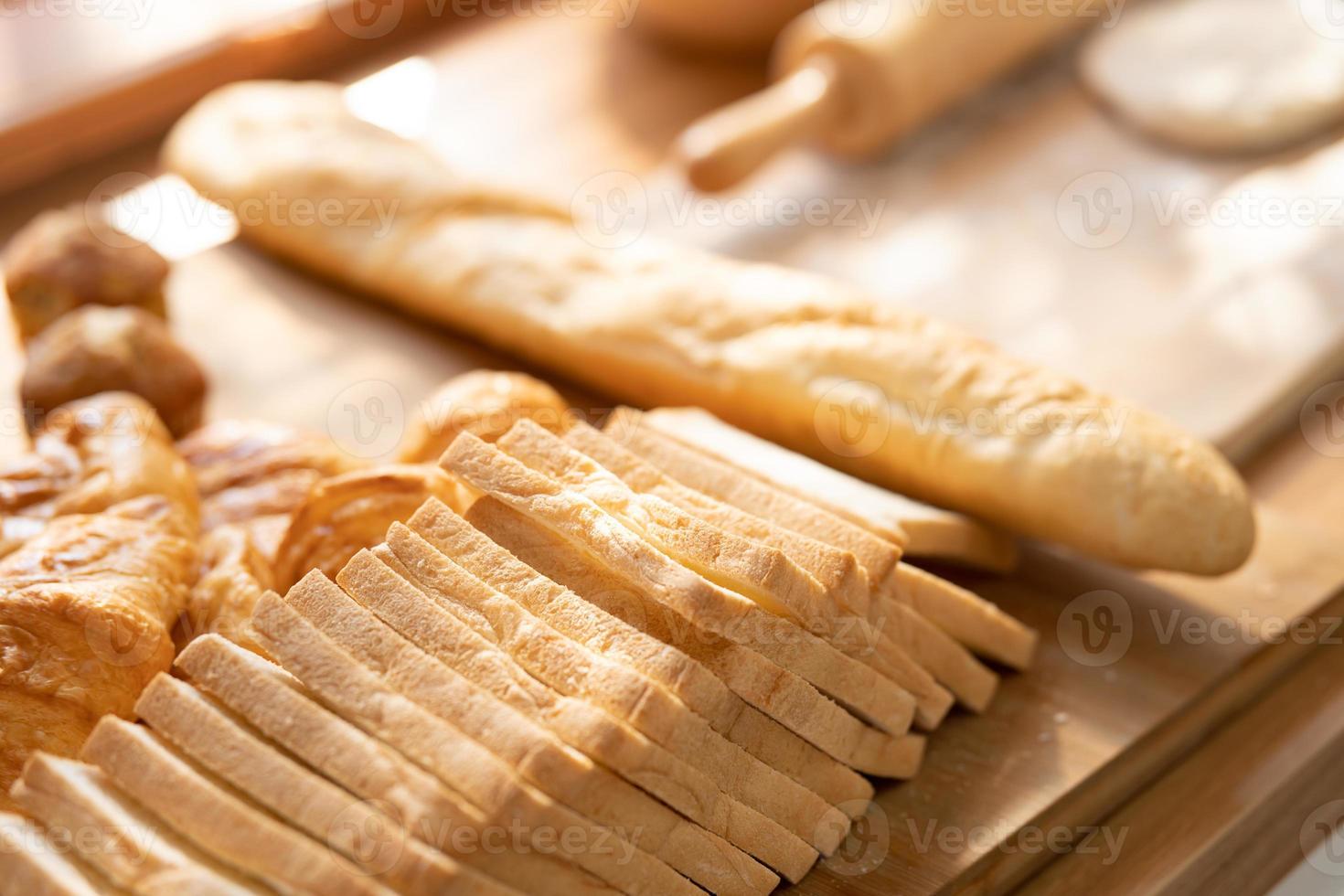 fresh bread and wheat on the wooden. Fresh fragrant bread on the table. Food concept. photo