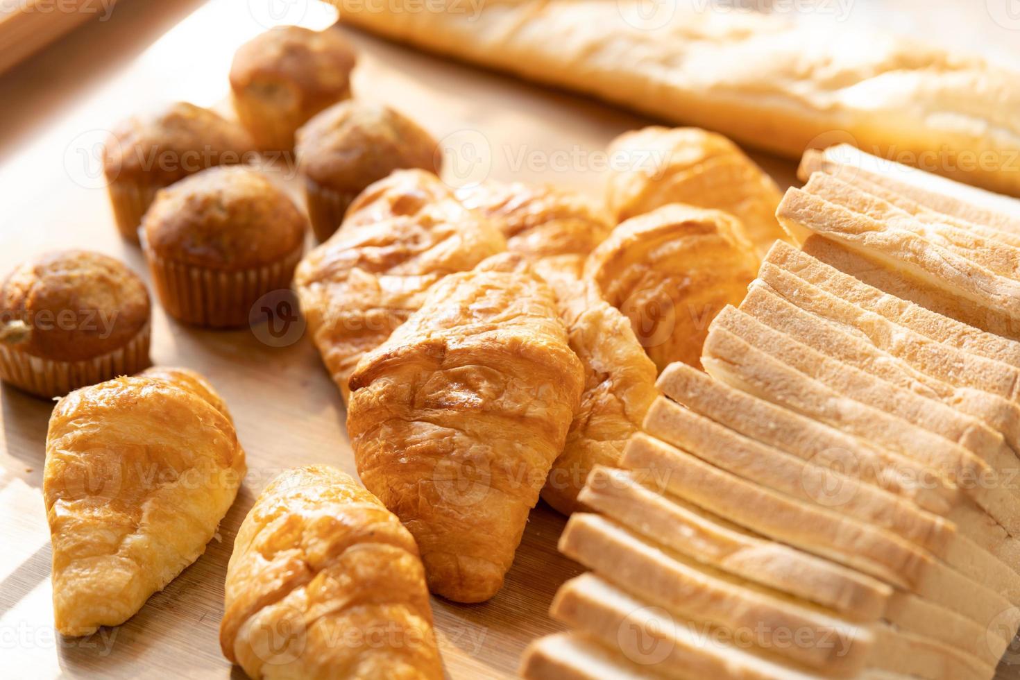 fresh bread and wheat on the wooden. Fresh fragrant bread on the table. Food concept. photo